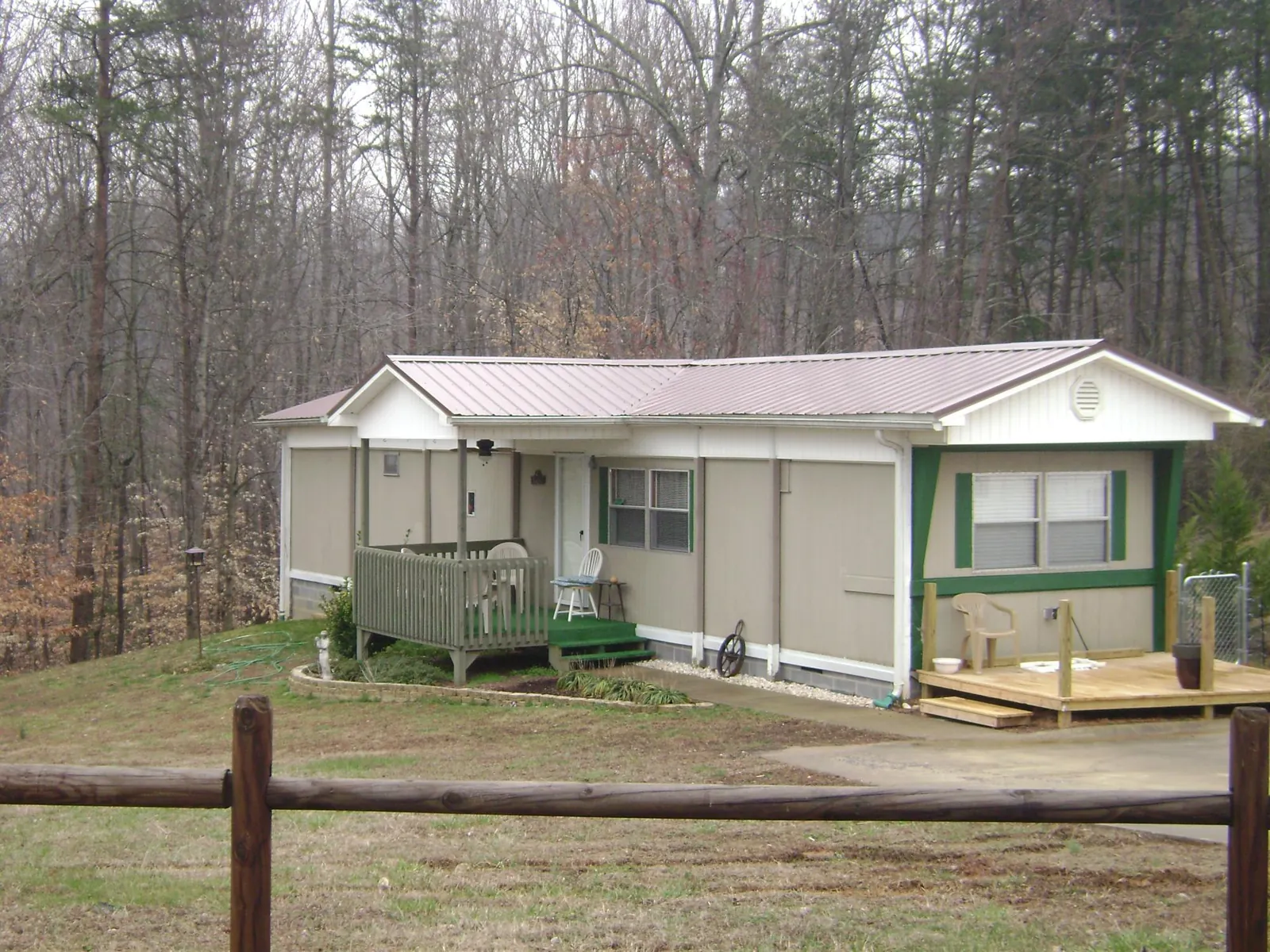 Mauve metal roof on a manufactured home with a new front deck in Shaniko